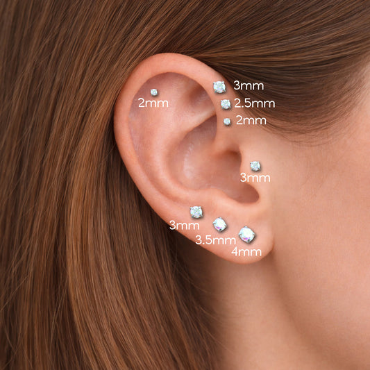 Curated ear with gold titanium threadless flat-back studs and moissanite tragus piercing